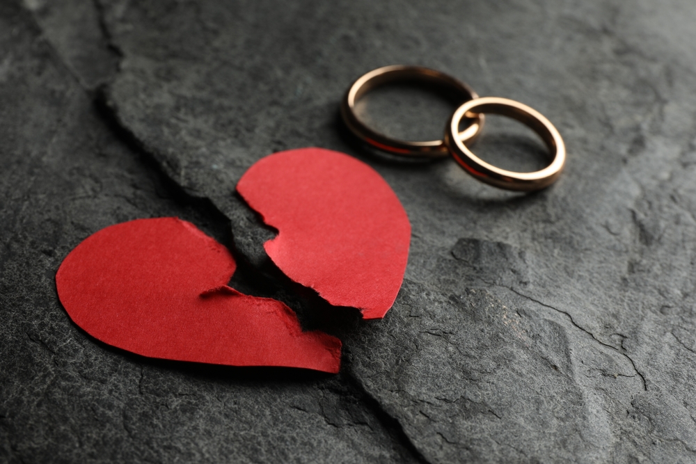 Couple sitting apart after Valentine’s Day, reflecting emotional disconnection that often leads to divorce in Colorado.